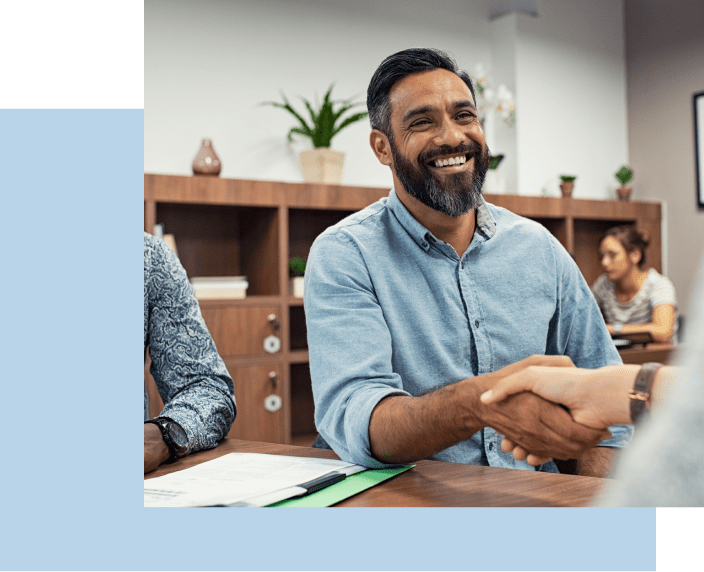 Man smiling while shaking hands